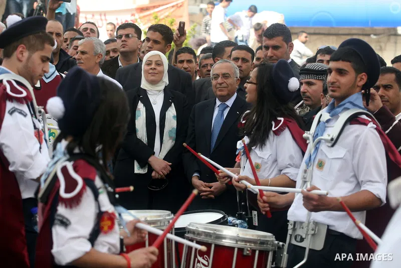 Palestinian Prime Minister Salam Fayyad takes part in the "Holy Fire" procession on the eve of Orthodox Easter in the West Bank city of Ramallah on April 14, 2012. The date of Orthodox Easter is calculated differently th...