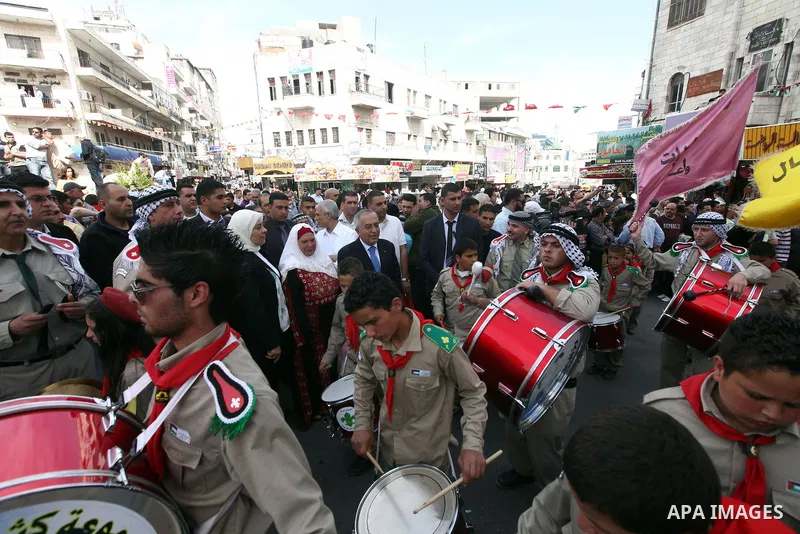 Palestinian Prime Minister Salam Fayyad takes part in the "Holy Fire" procession on the eve of Orthodox Easter in the West Bank city of Ramallah on April 14, 2012. The date of Orthodox Easter is calculated differently th...
