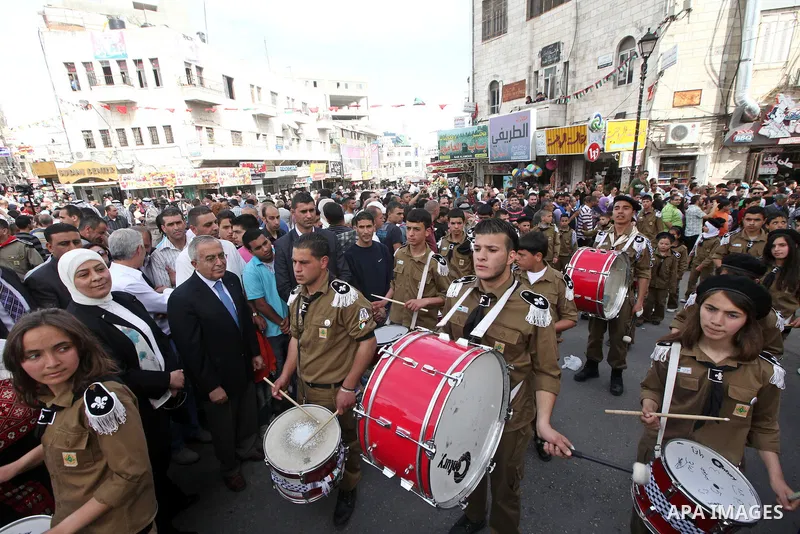 Palestinian Prime Minister Salam Fayyad takes part in the "Holy Fire" procession on the eve of Orthodox Easter in the West Bank city of Ramallah on April 14, 2012. The date of Orthodox Easter is calculated differently th...