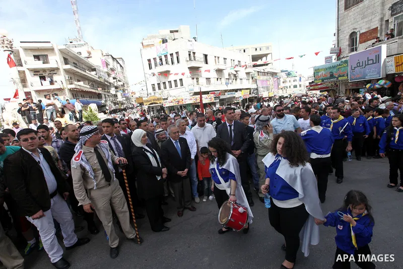 Palestinian Prime Minister Salam Fayyad takes part in the "Holy Fire" procession on the eve of Orthodox Easter in the West Bank city of Ramallah on April 14, 2012. The date of Orthodox Easter is calculated differently th...