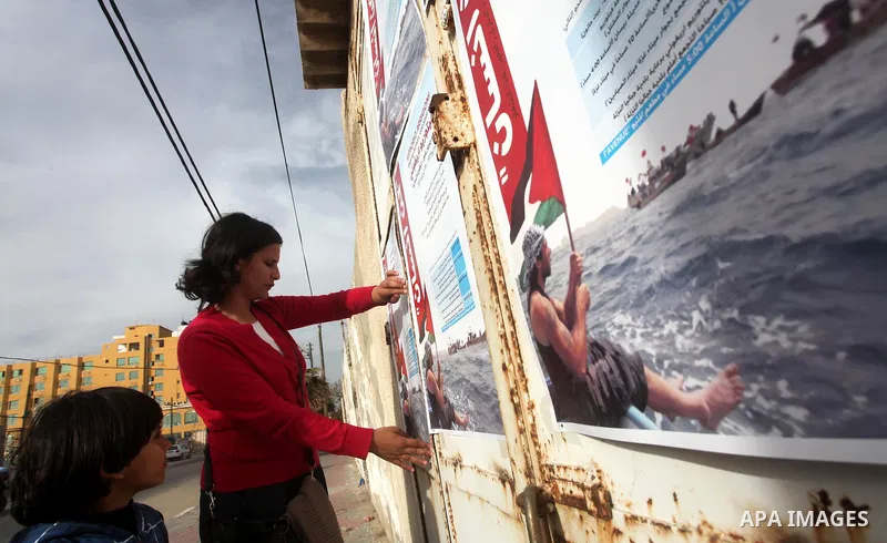 A Palestinian artist puts the final touches on a black and white mural painting dedicated to late Italian activist Vittorio Arrigoni in Gaza City on April 14, 2012, as Gazans marked the first anniversary of his murder in...