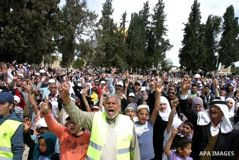 Palestinians gathers in front of Jerusalem's Dome of the Rock mosque inside the courtyard of the Al-Aqsa mosques compound, Islam's third holiest site, during a ceremony marking the international Children's Day on April 1...