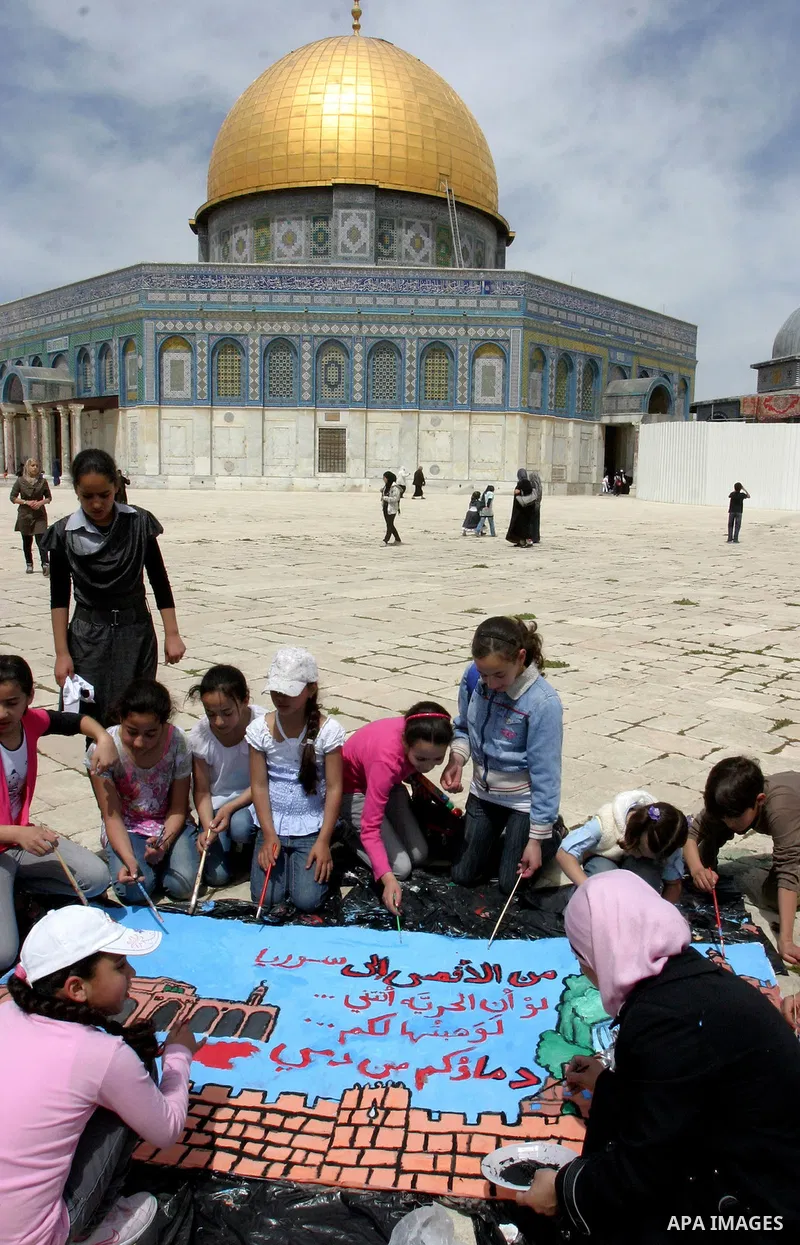 Palestinian girls gathers to play in front of Jerusalem's Dome of the Rock mosque inside the courtyard of the Al-Aqsa mosques compound, Islam's third holiest site, during a ceremony marking the international Children's D...