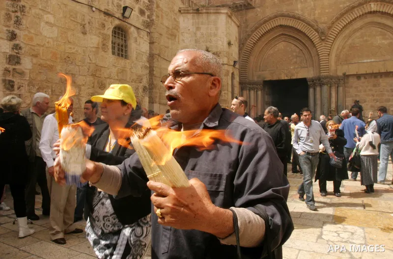 Palestinian Christians from the Greek Orthodox Church chant and sing in the streets with candles and crosses during the Easter Holy Fire ritual in the Old City of Jerusalem on April 14, 2012. during the 'Holy Fire' cerem...