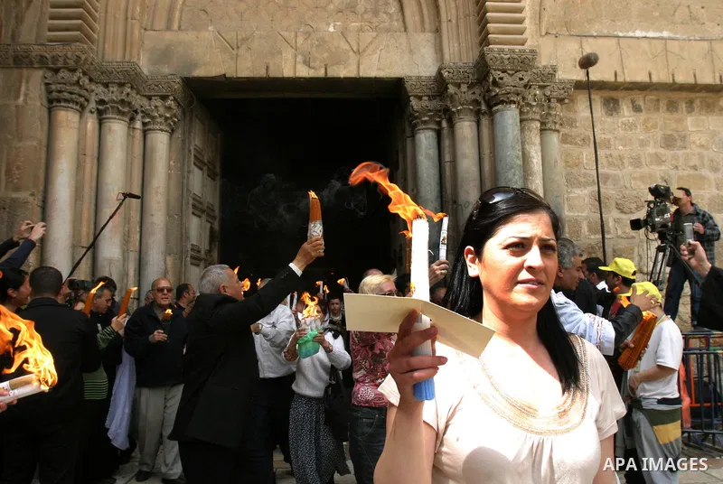 Palestinian Christians from the Greek Orthodox Church chant and sing in the streets with candles and crosses during the Easter Holy Fire ritual in the Old City of Jerusalem on April 14, 2012. during the 'Holy Fire' cerem...