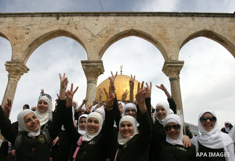 Palestinian girls gathers to play in front of Jerusalem's Dome of the Rock mosque inside the courtyard of the Al-Aqsa mosques compound, Islam's third holiest site, during a ceremony marking the international Children's D...