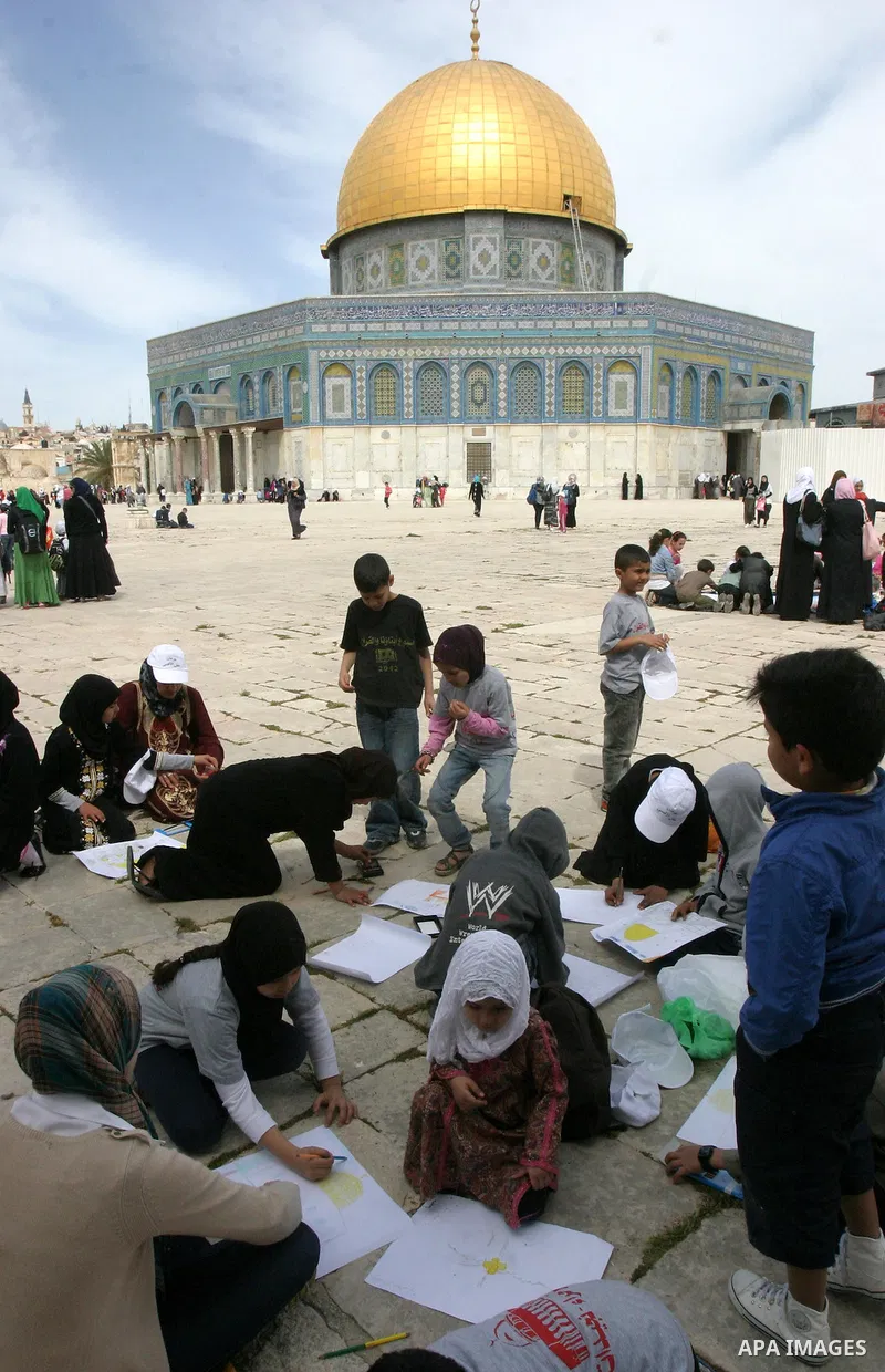 Palestinian girls gathers to play in front of Jerusalem's Dome of the Rock mosque inside the courtyard of the Al-Aqsa mosques compound, Islam's third holiest site, during a ceremony marking the international Children's D...
