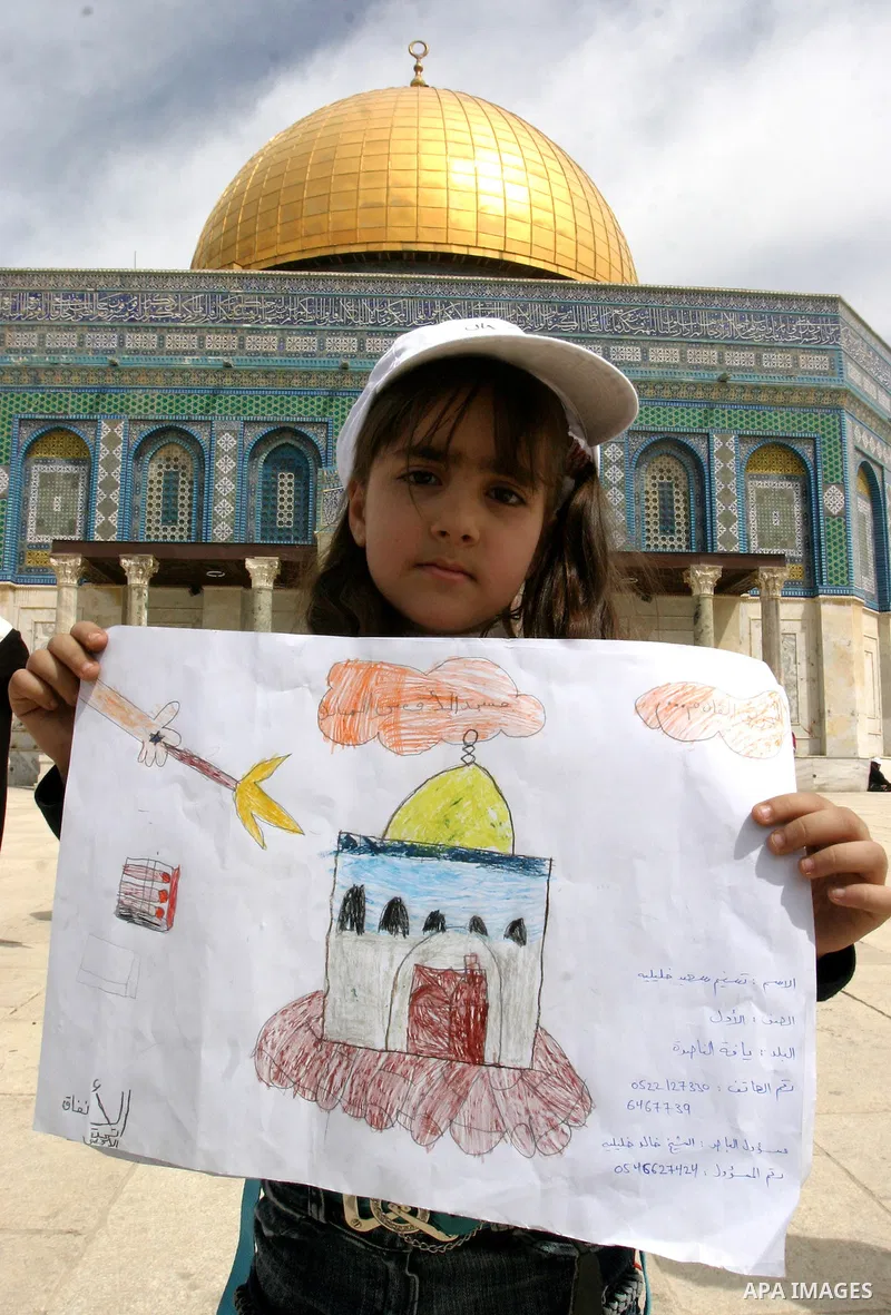 Palestinian girls gathers to play in front of Jerusalem's Dome of the Rock mosque inside the courtyard of the Al-Aqsa mosques compound, Islam's third holiest site, during a ceremony marking the international Children's D...