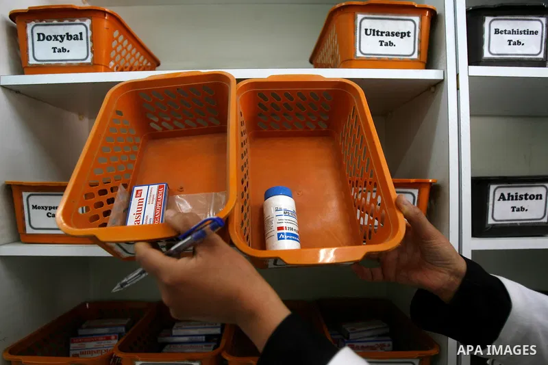 A Palestinian pharmacist stands next shelves which empty from medicines in hospital in Rafah southern Gaza Strip on April, 15, 2012 as Gaza Strip faces a lack of medicines. Photo by Eyad Al Baba