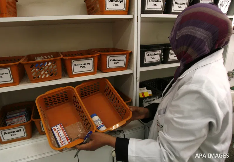 A Palestinian pharmacist stands next shelves which empty from medicines in hospital in Rafah southern Gaza Strip on April, 15, 2012 as Gaza Strip faces a lack of medicines. Photo by Eyad Al Baba