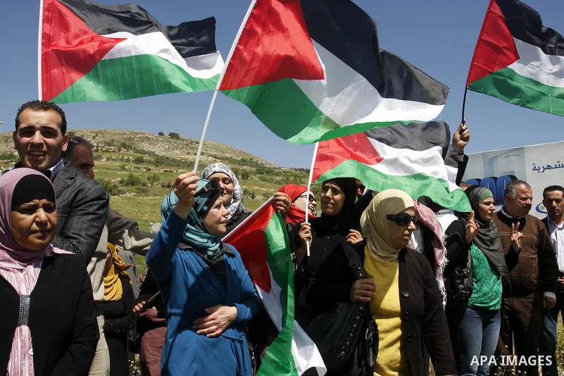Palestinians and foreign activists plant olive trees during a demonstration marking Palestinian Prisoners' Day ,in the Hawara checkpoint near the West Bank city of Nablus, Monday, April 16, 2012. Photo by Wagdi Eshtayah