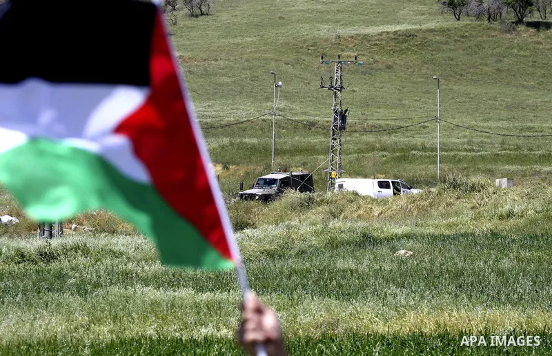Palestinians and foreign activists plant olive trees during a demonstration marking Palestinian Prisoners' Day ,in the Hawara checkpoint near the West Bank city of Nablus, Monday, April 16, 2012. Photo by Wagdi Eshtayah
