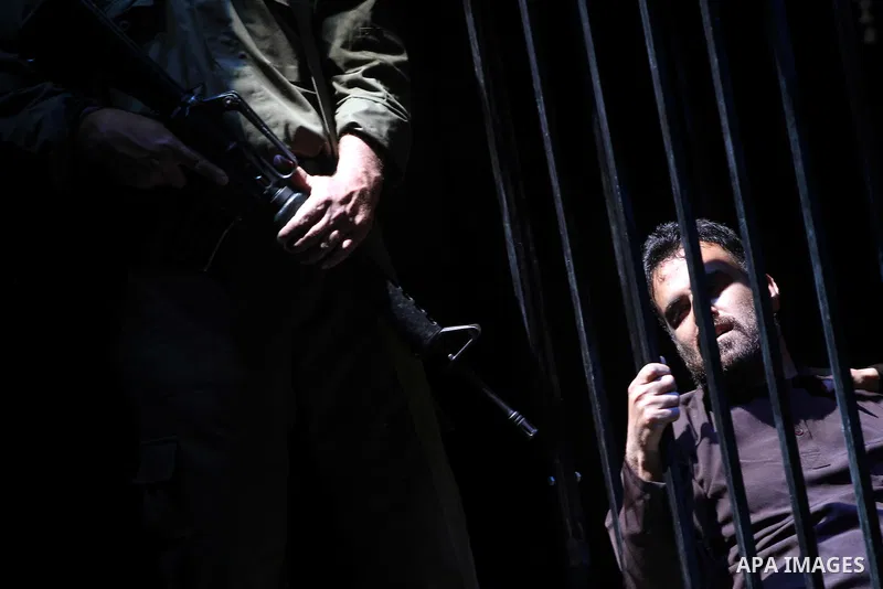Palestinians perform a play depicting Palestinian prisoners in an Israeli jail in Gaza City on April 16, 2012 on the eve of Prisoners' Day, an annual event during which people hold demonstrations and rallies of solidarit...