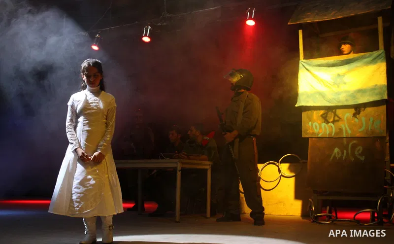 Palestinians perform a play depicting Palestinian prisoners in an Israeli jail in Gaza City on April 16, 2012 on the eve of Prisoners' Day, an annual event during which people hold demonstrations and rallies of solidarit...