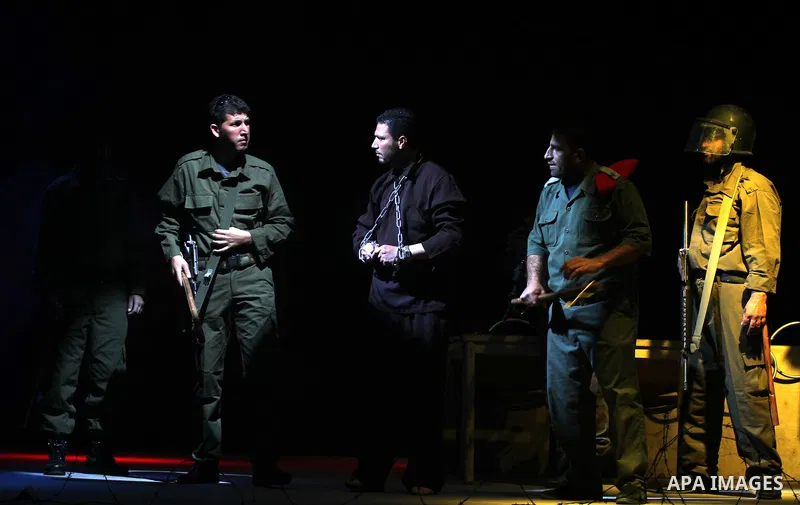 Palestinians perform a play depicting Palestinian prisoners in an Israeli jail in Gaza City on April 16, 2012 on the eve of Prisoners' Day, an annual event during which people hold demonstrations and rallies of solidarit...