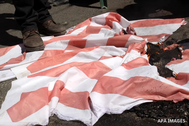 Palestinians burn Israel's national flag during a rally in front of the Red Cross headquarters in Gaza City marking Palestinian Prisoners Day April 17, 2012. The Israeli Prisons Authority said on Tuesday in a written sta...