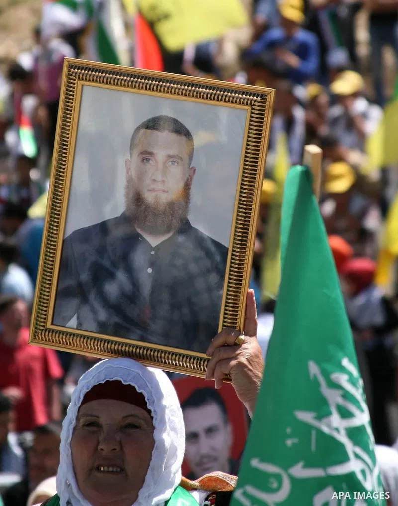 Palestinian protesters wave national flags during a rally in West Bank city of Hebron on April 17, 2012 in solidarity with Palestinian prisoners held in Israel. Some 1,200 Palestinian prisoners held in Israeli jails have...
