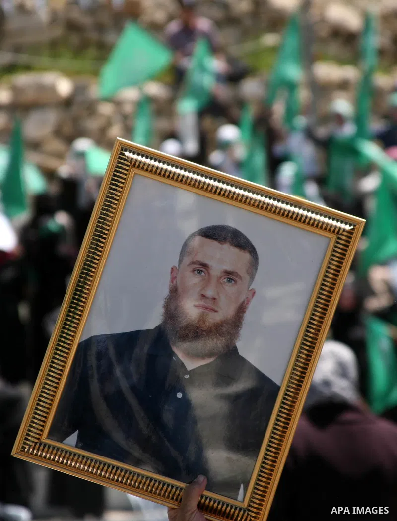 Palestinian protesters wave national flags during a rally in West Bank city of Hebron on April 17, 2012 in solidarity with Palestinian prisoners held in Israel. Some 1,200 Palestinian prisoners held in Israeli jails have...
