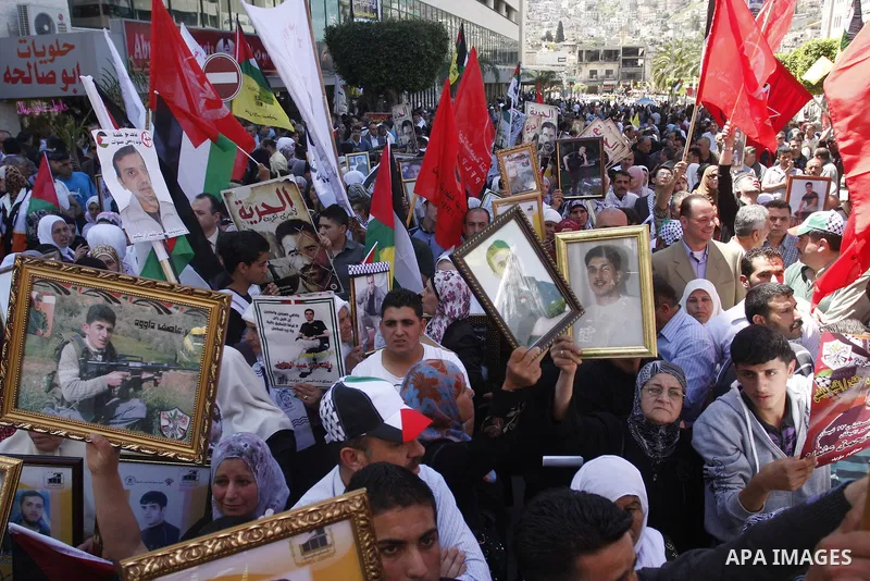 Palestinians participate in a demonstration calling for the release of Palestinian prisoners jailed in Israel, in the West Bank city of Nablus,Israel is currently 1,200 of Palestinians in its prisons. have begun a hunger...
