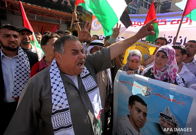 Palestinians demonstrate in solidarity with prisoners jailed in Israel on the annual prisoners day, in Gaza City, Tuesday, April 17, 2012. The Israeli prison service said Tuesday hundreds of Palestinian prisoners have la...