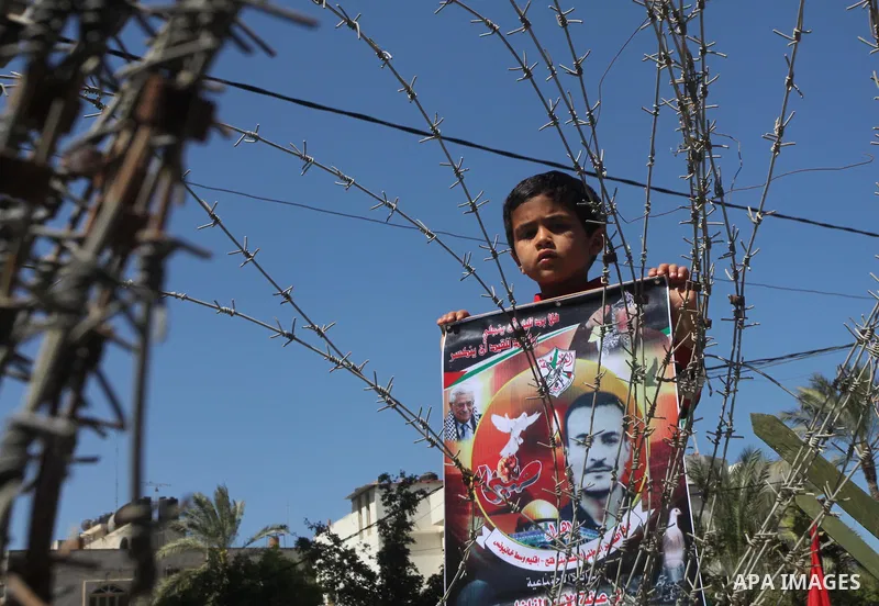 Palestinian boys with handcuffs attend a rally to commemorate the Palestinian Prisoner Day in Gaza City, on April 17, 2012. The Israeli Prisons Authority said on Tuesday in a written statement that 2,300 Palestinian pris...