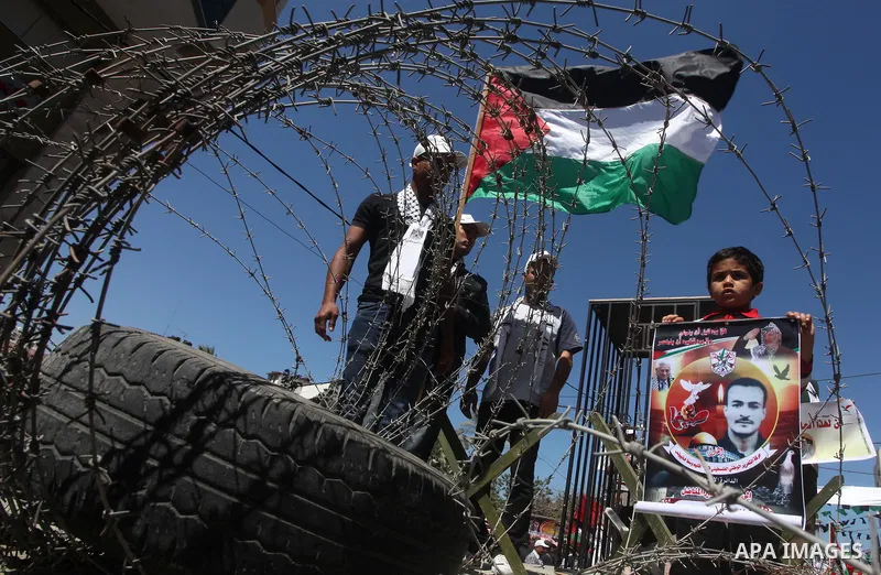 Palestinian boys with handcuffs attend a rally to commemorate the Palestinian Prisoner Day in Gaza City, on April 17, 2012. The Israeli Prisons Authority said on Tuesday in a written statement that 2,300 Palestinian pris...
