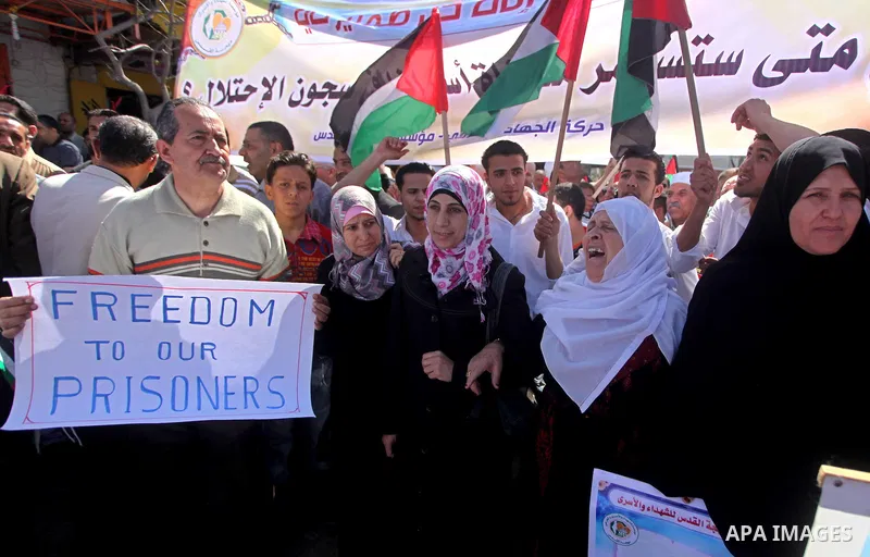 Palestinians demonstrate in solidarity with prisoners jailed in Israel on the annual prisoners day, in Gaza City, Tuesday, April 17, 2012. The Israeli prison service said Tuesday hundreds of Palestinian prisoners have la...
