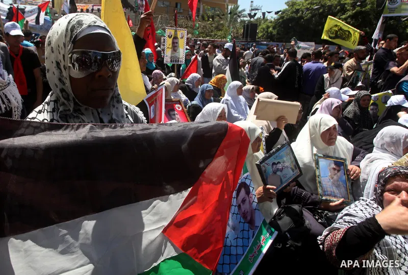 Palestinians demonstrate in solidarity with prisoners jailed in Israel on the annual prisoners day, in Gaza City, Tuesday, April 17, 2012. The Israeli prison service said Tuesday hundreds of Palestinian prisoners have la...