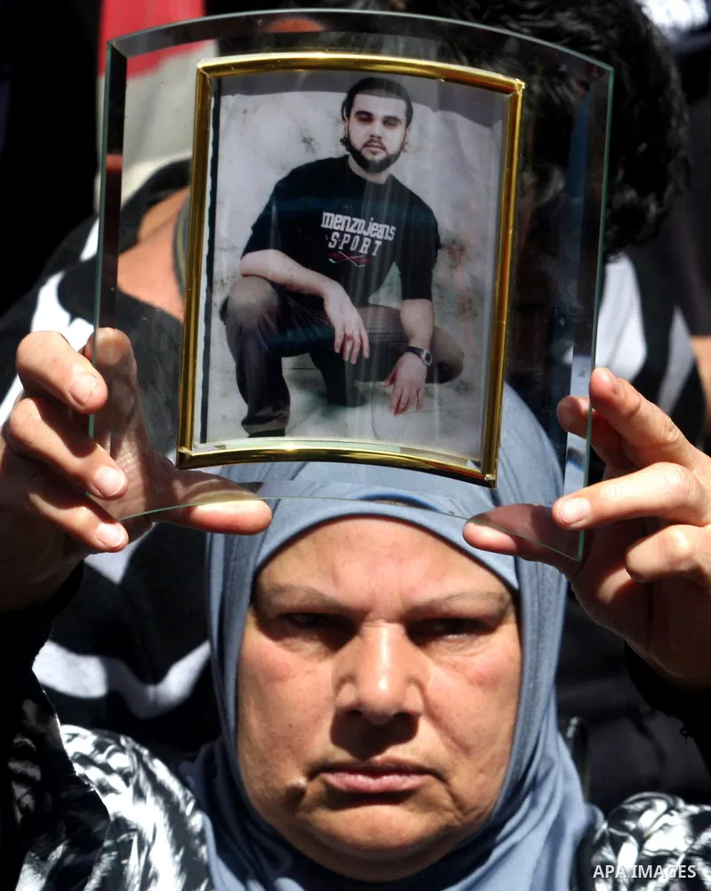 Palestinians hold a photograph of a prisoner jailed in Israel, during a rally marking the annual prisoners' day in the West Bank city of Ramallah, Tuesday, April 17, 2012. Hundreds of Palestinian prisoners held by Israel...