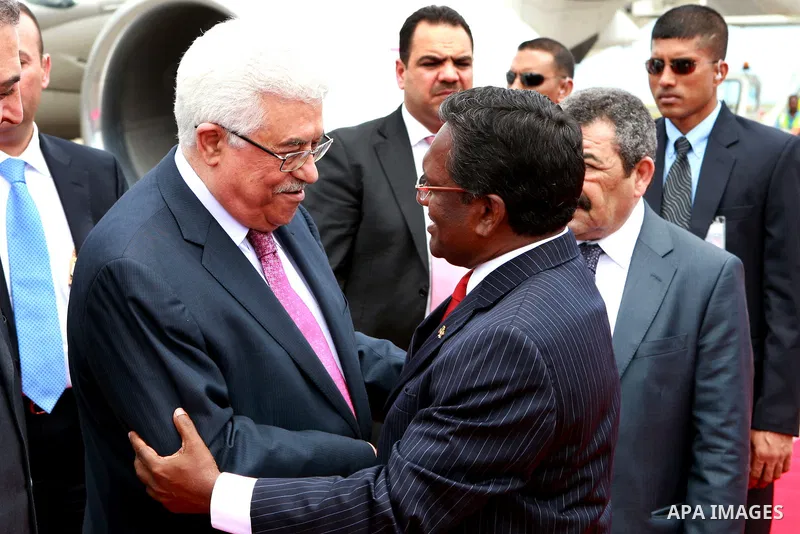 Palestinian President Mahmoud Abbas, received by Maldives President, Mohammed Waheed Hassan, upon arrival at the airport in Male, Maldives, Tuesday, April 17, 2012. Photo by Thaer Ganaim