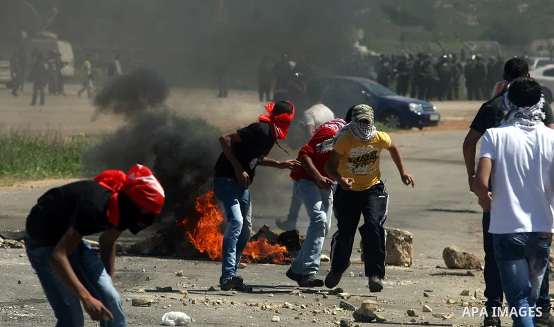 A Palestinian protester accidentally sets himself on fire while throwing a Molotov cocktail towards the Israeli soldiers during clashes following a demonstration to mark the Prisoners' Day near Israels Ofer prison, betw...