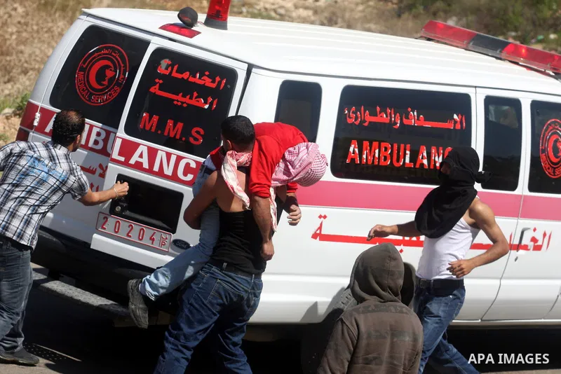 A Palestinian carries an injured demonstrator during clashes with Israeli troops outside Ofer military prison near the West Bank city of Ramallah, on the annual "Prisoners' Day", Tuesday, April 17, 2012. Hundreds of Pale...