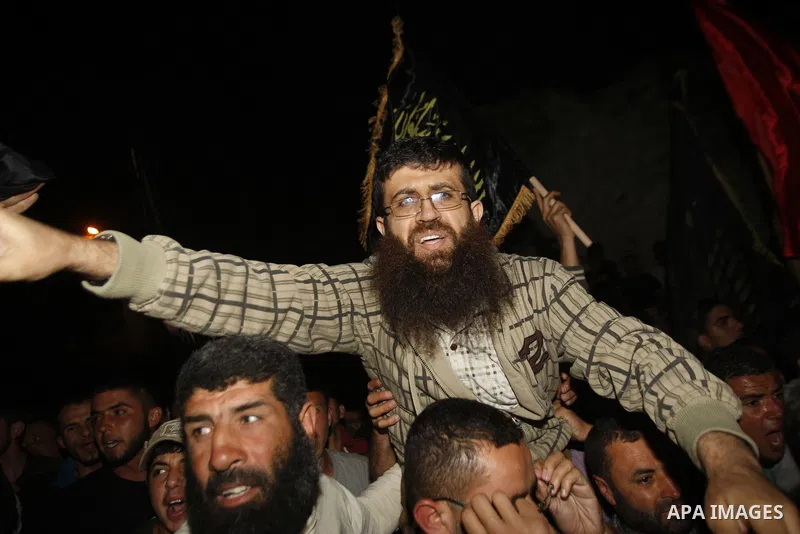 Khader Adnan, a member of Islamic Jihad, gestures upon his arrival in the West Bank village of Arabe near Jenin after his release from an Israeli prison, April 17, 2012. Adnan, a prisoner who refused food for 66 days bef...