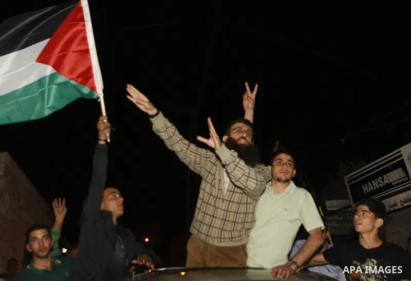 Khader Adnan, a member of Islamic Jihad, gestures upon his arrival in the West Bank village of Arabe near Jenin after his release from an Israeli prison, April 17, 2012. Adnan, a prisoner who refused food for 66 days bef...