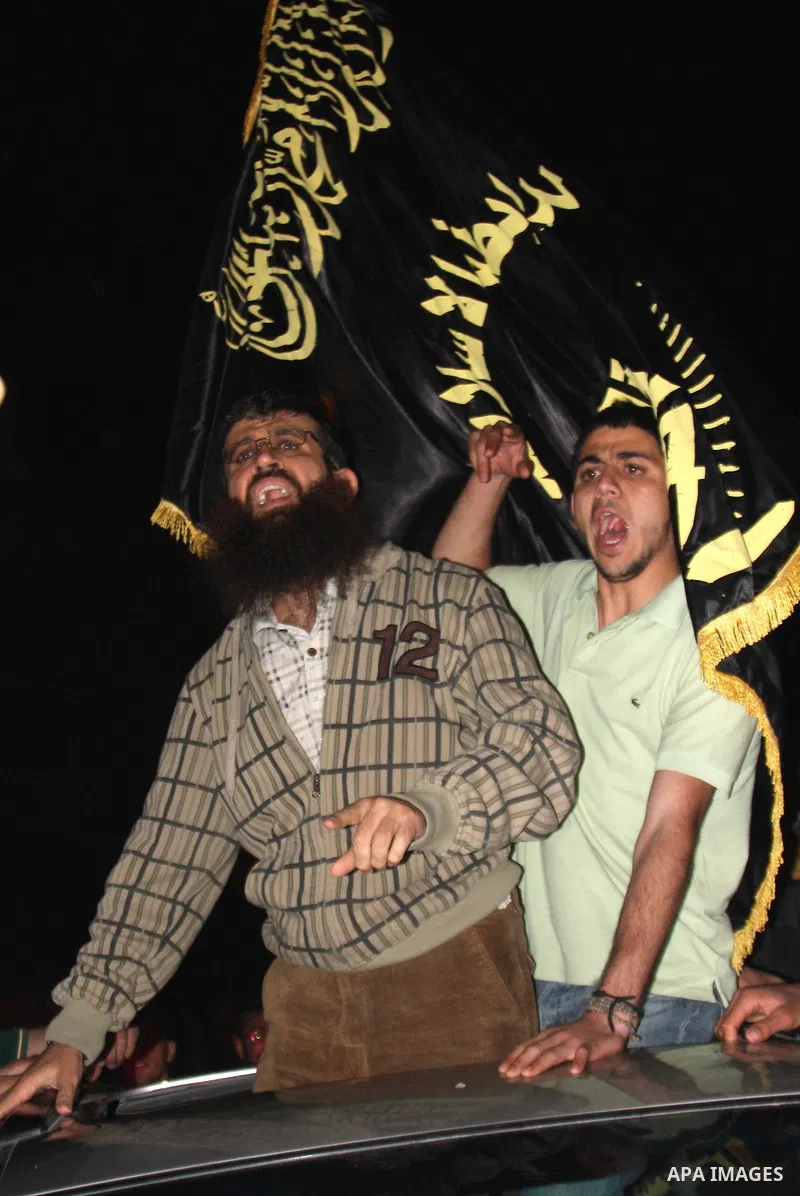 Khader Adnan, a member of Islamic Jihad, gestures upon his arrival in the West Bank village of Arabe near Jenin after his release from an Israeli prison, April 17, 2012. Adnan, a prisoner who refused food for 66 days bef...