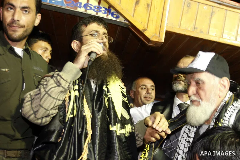 Khader Adnan, a member of Islamic Jihad, gestures upon his arrival in the West Bank village of Arabe near Jenin after his release from an Israeli prison, April 17, 2012. Adnan, a prisoner who refused food for 66 days bef...