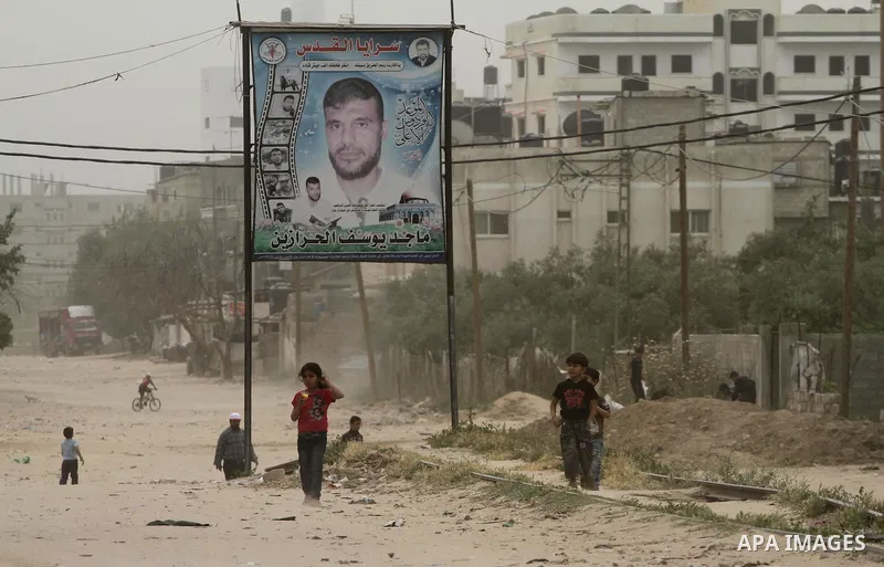 Palestinian children play on the street during hot winds and sand storms in Gaza City on April 18, 2012. Photo by Mohammed Asad