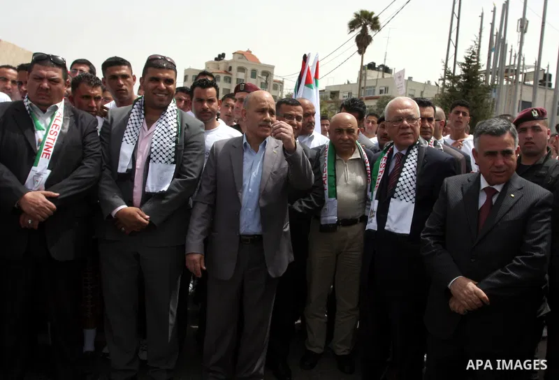 Palestinians take part the athletes during run in the Olympic Marathon (100 days before the start of the London Olympics 2012) in the West Bank city of Ramallah April 18, 2012. Photo by Issam Rimawi