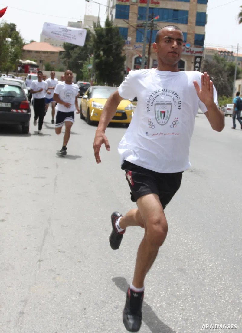Palestinian athletes ran in the Olympic Marathon (100 days before the start of the London Olympics 2012) in the West Bank city of Ramallah April 18, 2012. Photo by Issam Rimawi