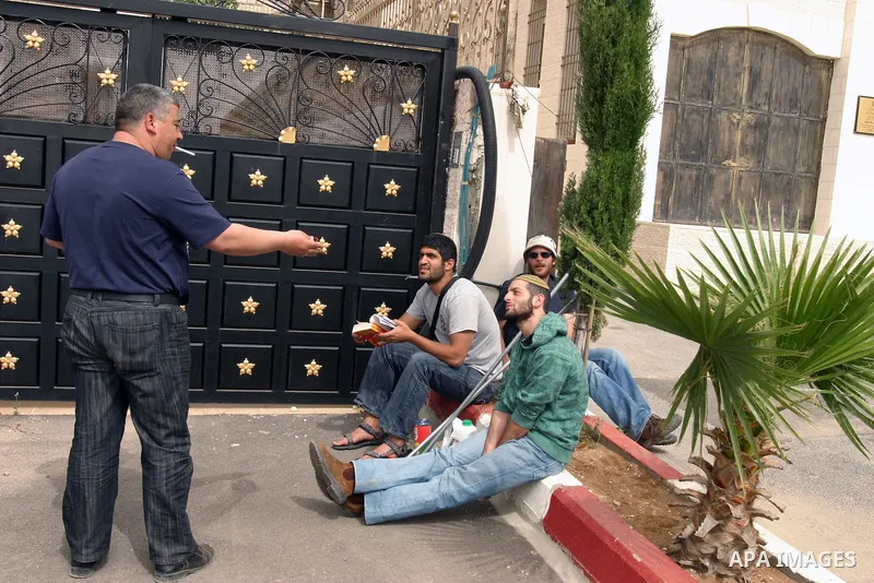 Israeli police stand guard as Palestinian members of the Khaled Natsheh household remove household items after being forced to hand over their home to Jewish settlers in the Israeli annexed east Jerusalem neighbourhood o...