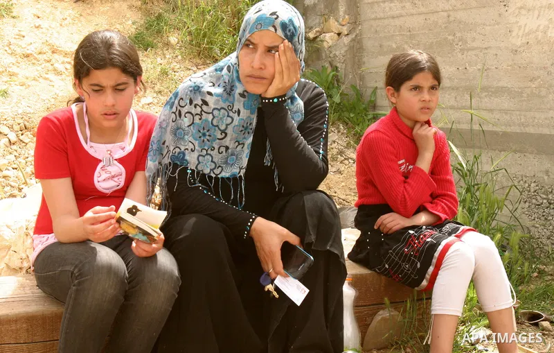 Female Palestinian members of the Khaled Natsheh household look on as their furniture is removed following their forced eviction by Israeli authorities, handing over their home to Jewish settlers in the Israeli annexed e...