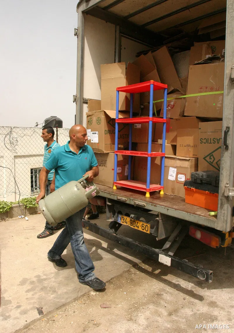Palestinian members of the Khaled Natsheh household transfer on as their furniture is removed following their forced eviction by Israeli authorities, handing over their home to Jewish settlers in the Israeli annexed east...