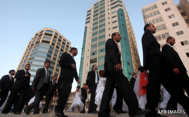 Palestinians celebrate during a mass wedding organized by Association of Altayseer for marriage. Around 60 young Palestinians Participated in the wedding in Gaza City on April 19, 2012. Photo by Ashraf Amra