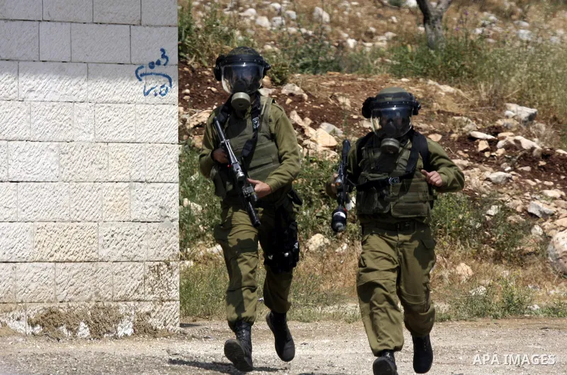 Israeli soldiers fire teargas canisters against Palestinian protesters as they demonstrate against the expropriation of Palestinian land by Israel in the village of Kafr Qaddum, near the northern city of Nablus in the oc...