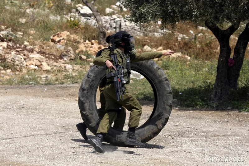 Israeli soldiers fire teargas canisters against Palestinian protesters as they demonstrate against the expropriation of Palestinian land by Israel in the village of Kafr Qaddum, near the northern city of Nablus in the oc...