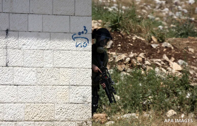 Israeli soldiers fire teargas canisters against Palestinian protesters as they demonstrate against the expropriation of Palestinian land by Israel in the village of Kafr Qaddum, near the northern city of Nablus in the oc...