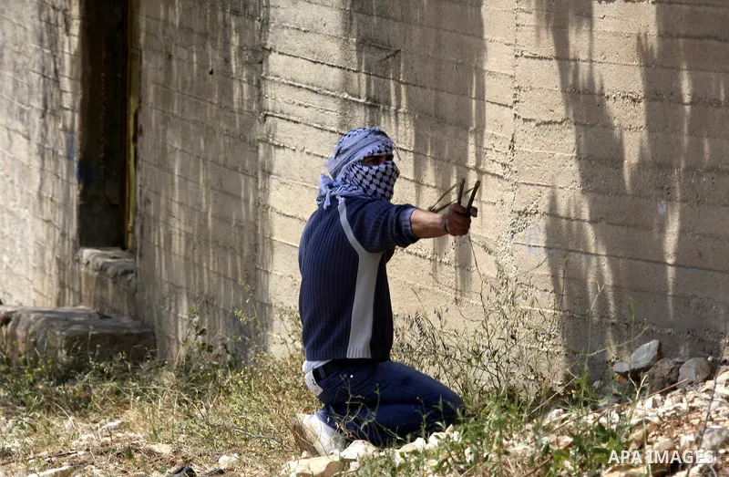 A Palestinian protester readies to throw a stone at the Israeli military during a demonstration against the expropriation of Palestinian land by Israel in the village of Kafr Qaddum, near the northern city of Nablus in t...