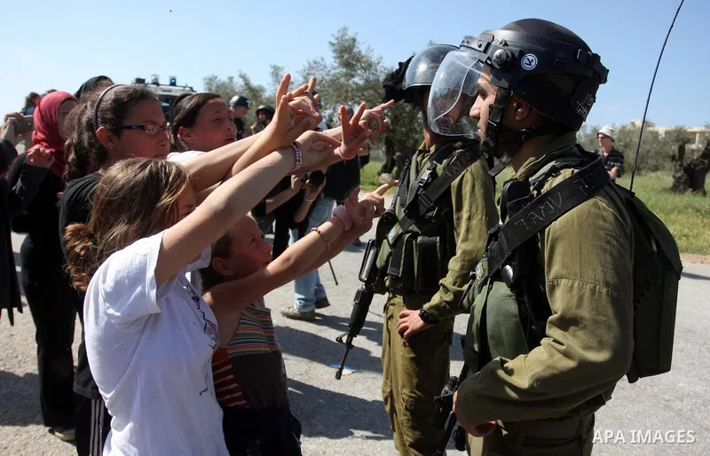 Palestinian and foreign activists confront Israeli soldiers during clashes in the weekly Friday demonstration in the West Bank village of Nabi Saleh, on April 20, 2012, against the construction of the nearby Jewish settl...