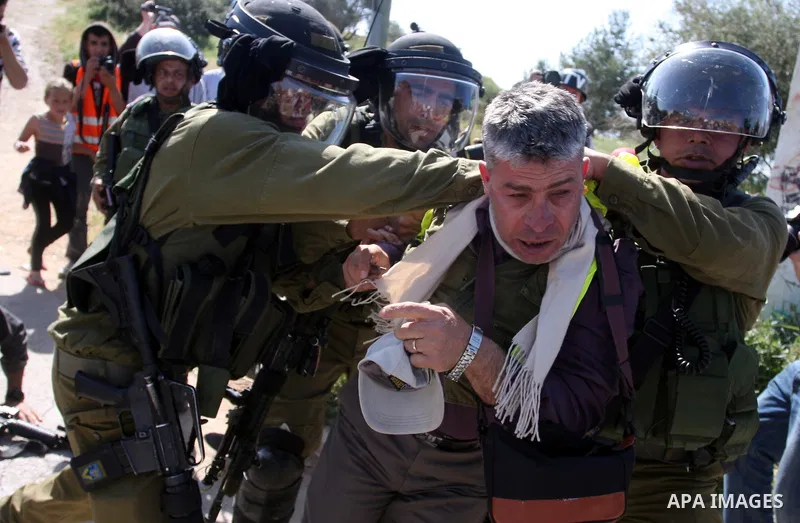 Palestinian and foreign activists confront Israeli soldiers during clashes in the weekly Friday demonstration in the West Bank village of Nabi Saleh, on April 20, 2012, against the construction of the nearby Jewish settl...