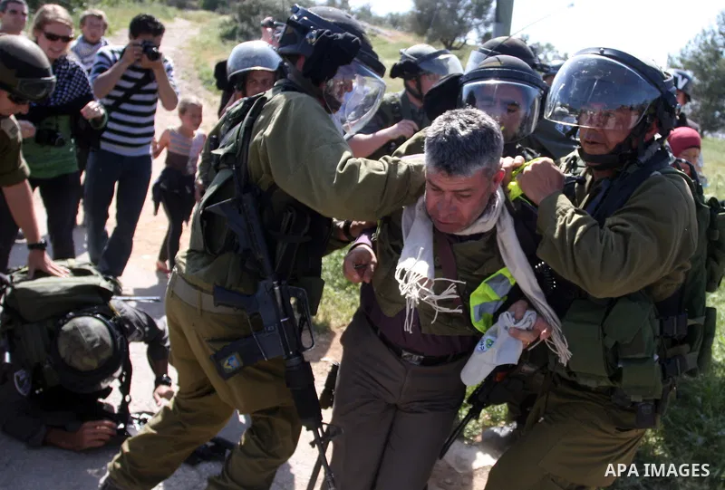 Palestinian and foreign activists confront Israeli soldiers during clashes in the weekly Friday demonstration in the West Bank village of Nabi Saleh, on April 20, 2012, against the construction of the nearby Jewish settl...
